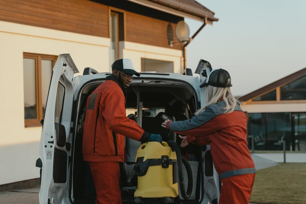 Pexels Licence - Tima Miroshnichenko Two cleaners getting equipment out of a van